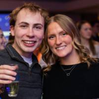 Two grads smile and cheers together